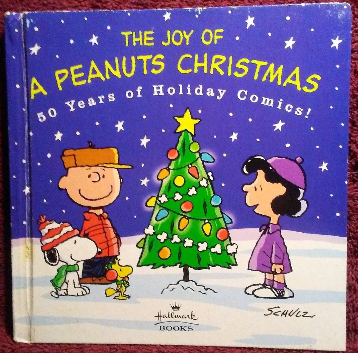 The Joy of a Peanuts Christmas ; 50 Years of Holiday Comics by Megan Bossuyt,Erin Slonaker